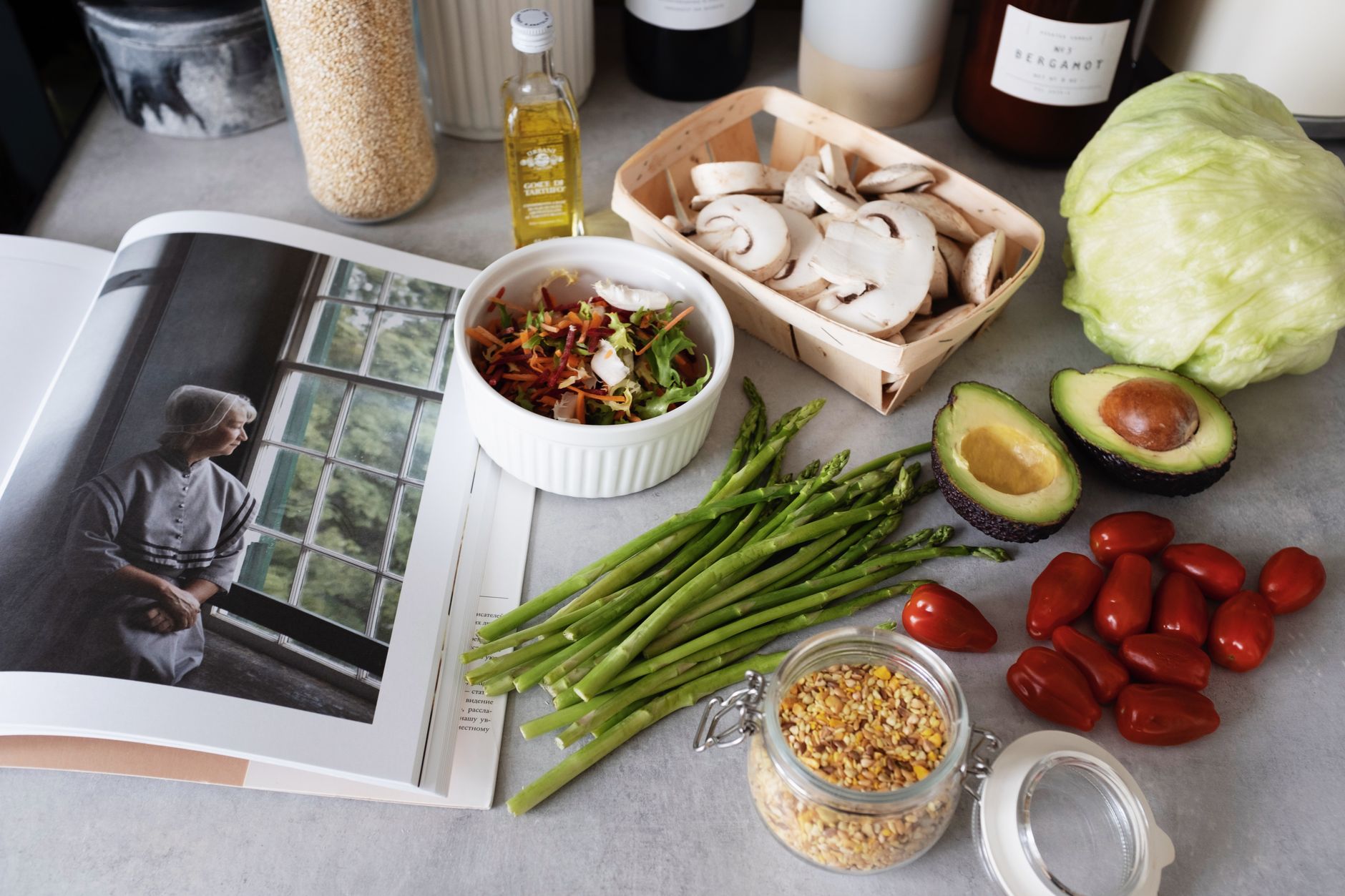 A selection of fresh vegetables and a cookbook in a kitchen setting, promoting healthy cooking. — Elements Smokehouse: Enjoy